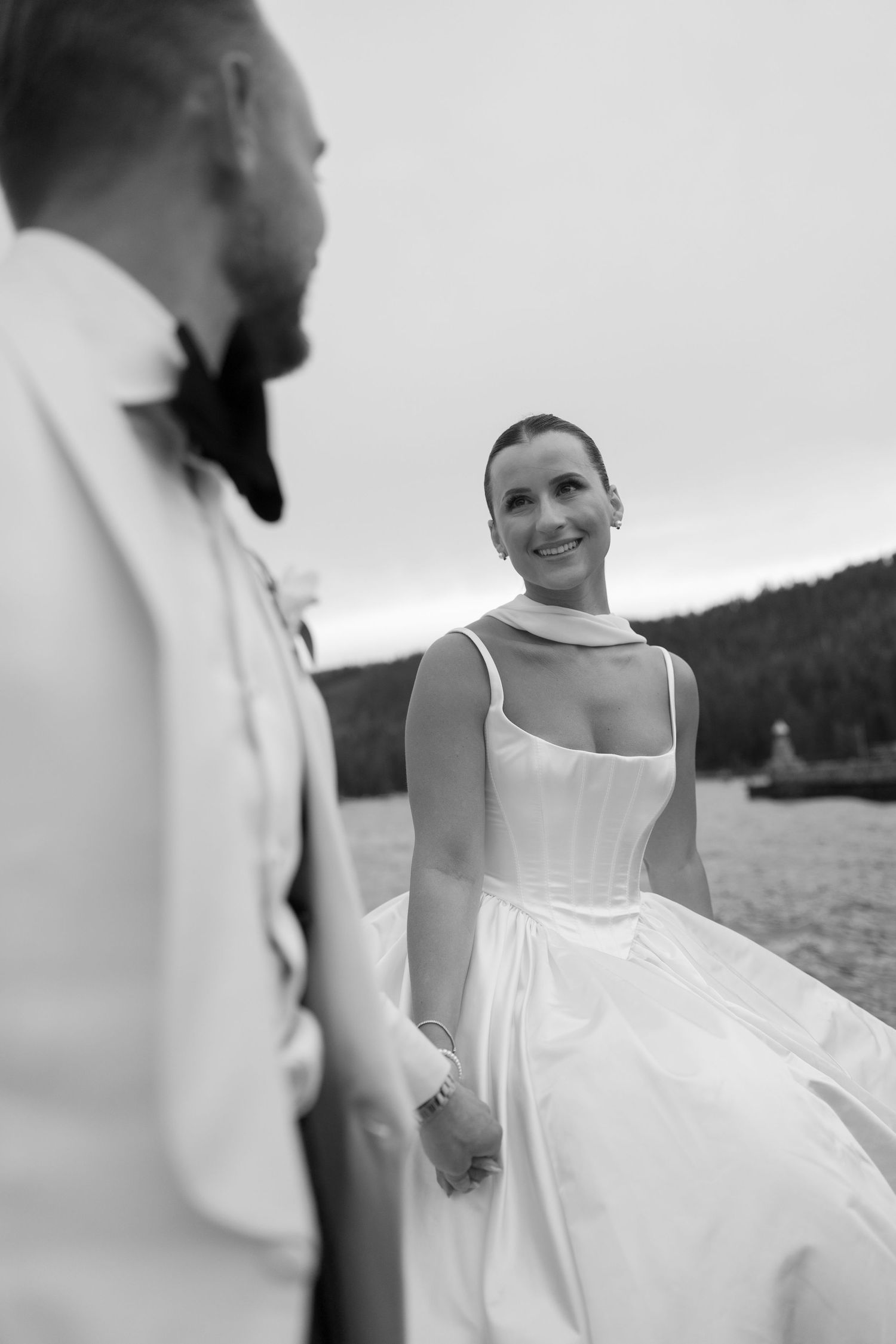 Black and white candid moments captured on a boat with flowing fabric in the breeze.