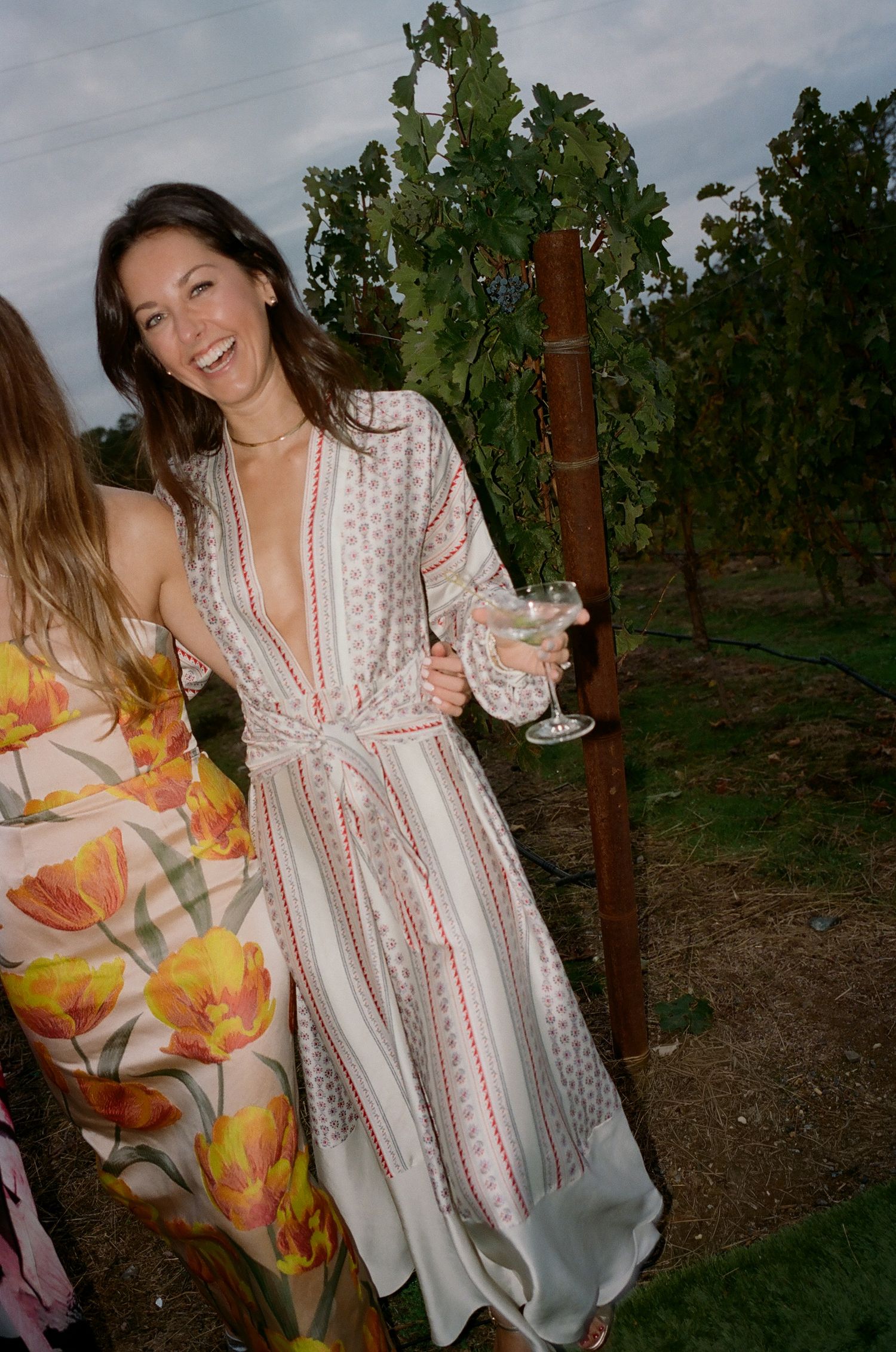 Casual photoshoot in a vineyard with floral patterns and bohemian style clothing.