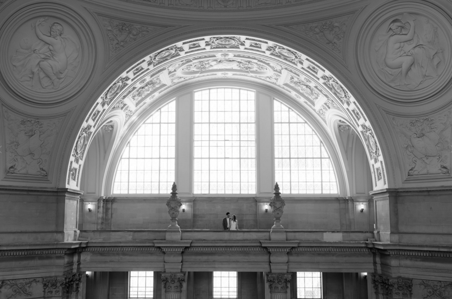 Ornate architectural details of a grand cathedral ceiling with arched windows and decorative moldings.