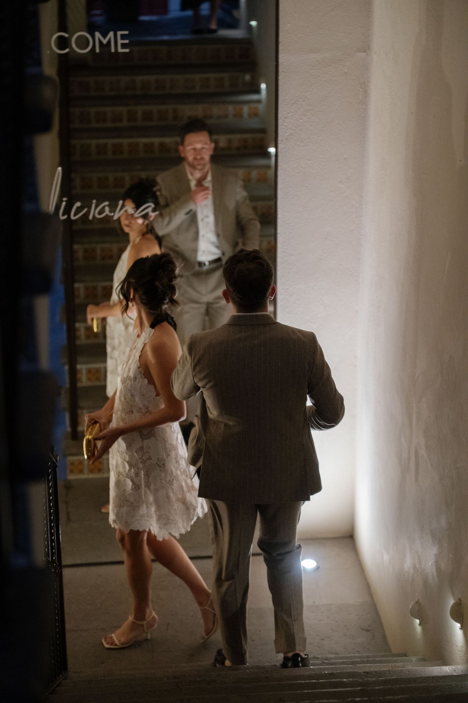 Dimly lit indoor sequence showing movement and dancing in an intimate space.