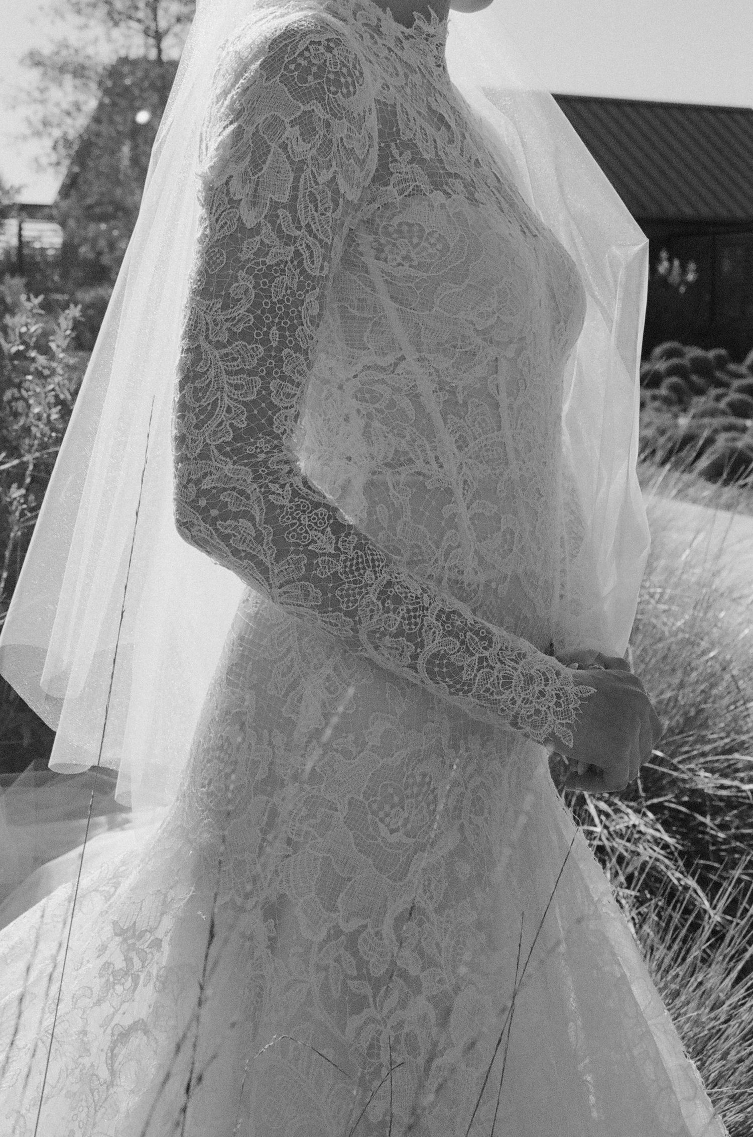 Close-up details of intricate lace on a white wedding dress veil.