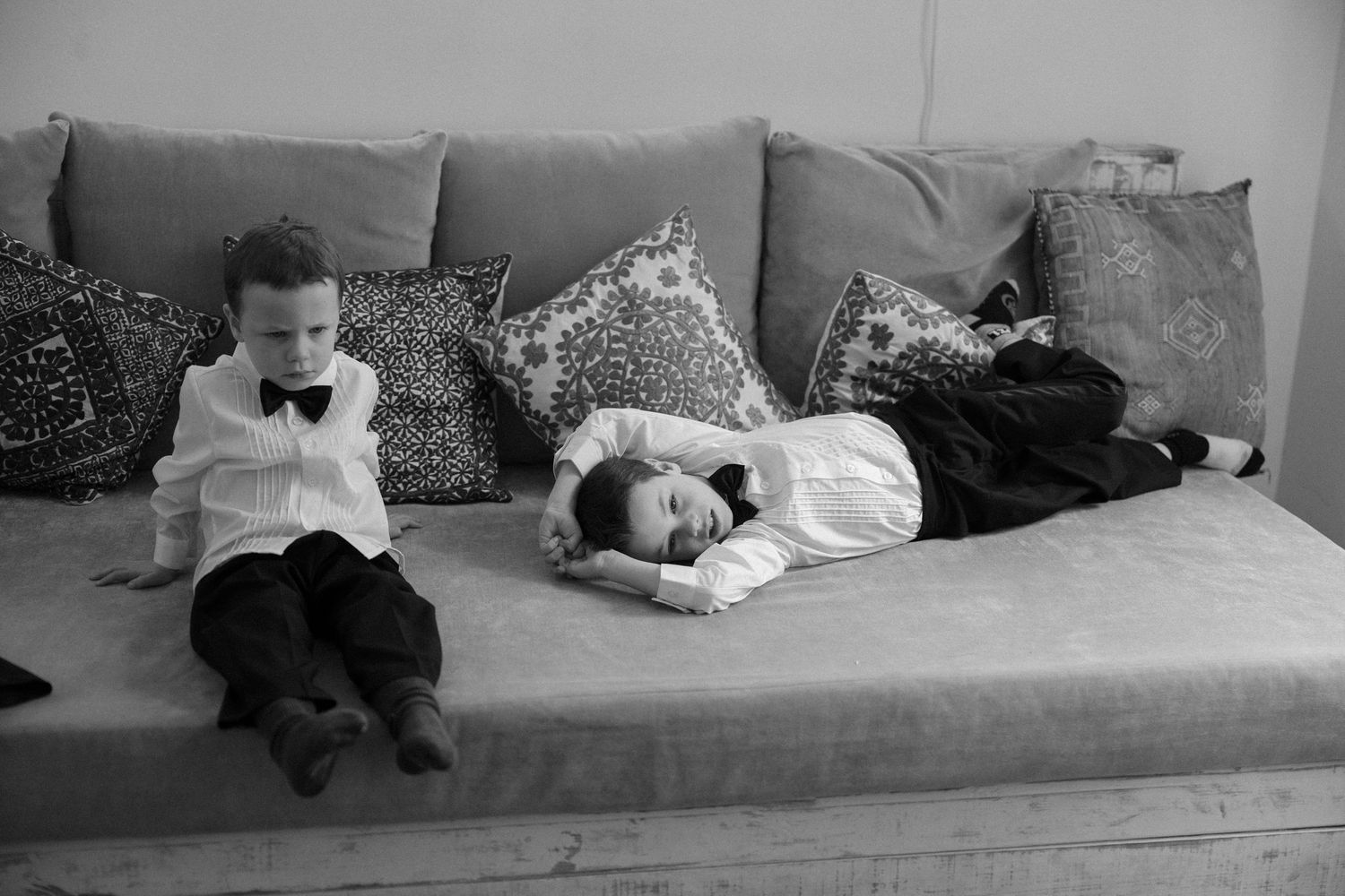 A series of black and white photos showing people resting on a couch in different poses.