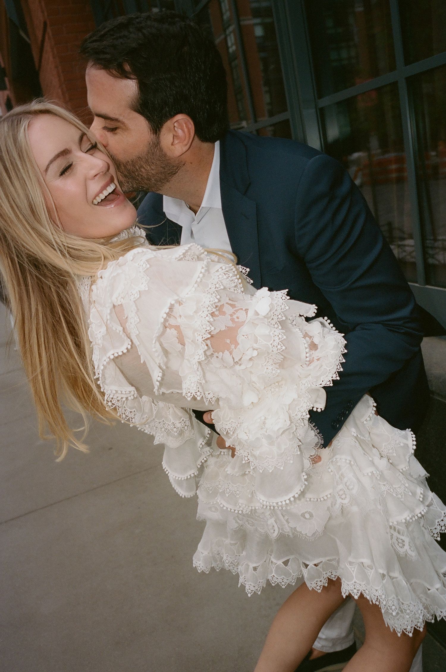 A romantic dance dip captured in an urban setting.