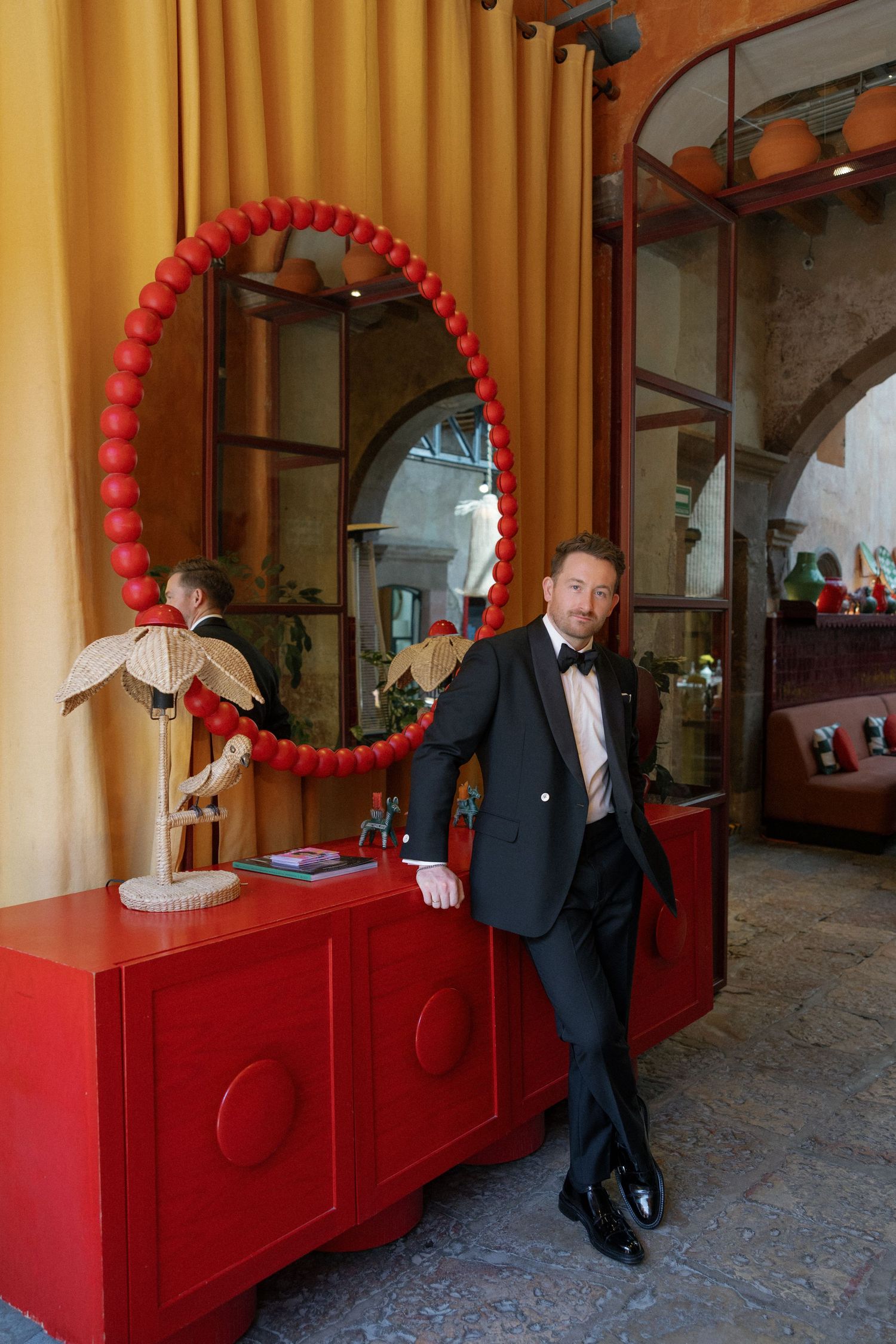 Series of photos showing people posing against a red and gold wall with balloon decorations.