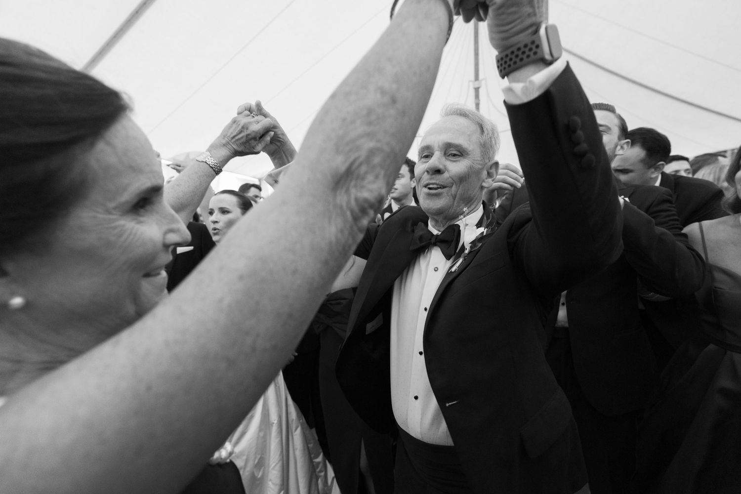 Black and white candid shots of celebratory moments during a wedding reception.