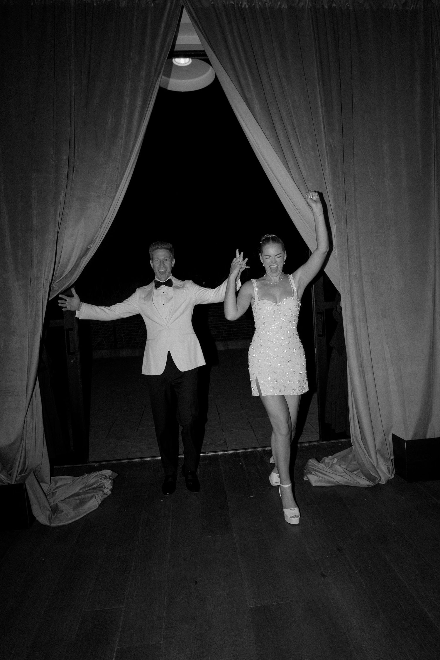 Wedding celebration dance moves captured in dramatic black and white photography.