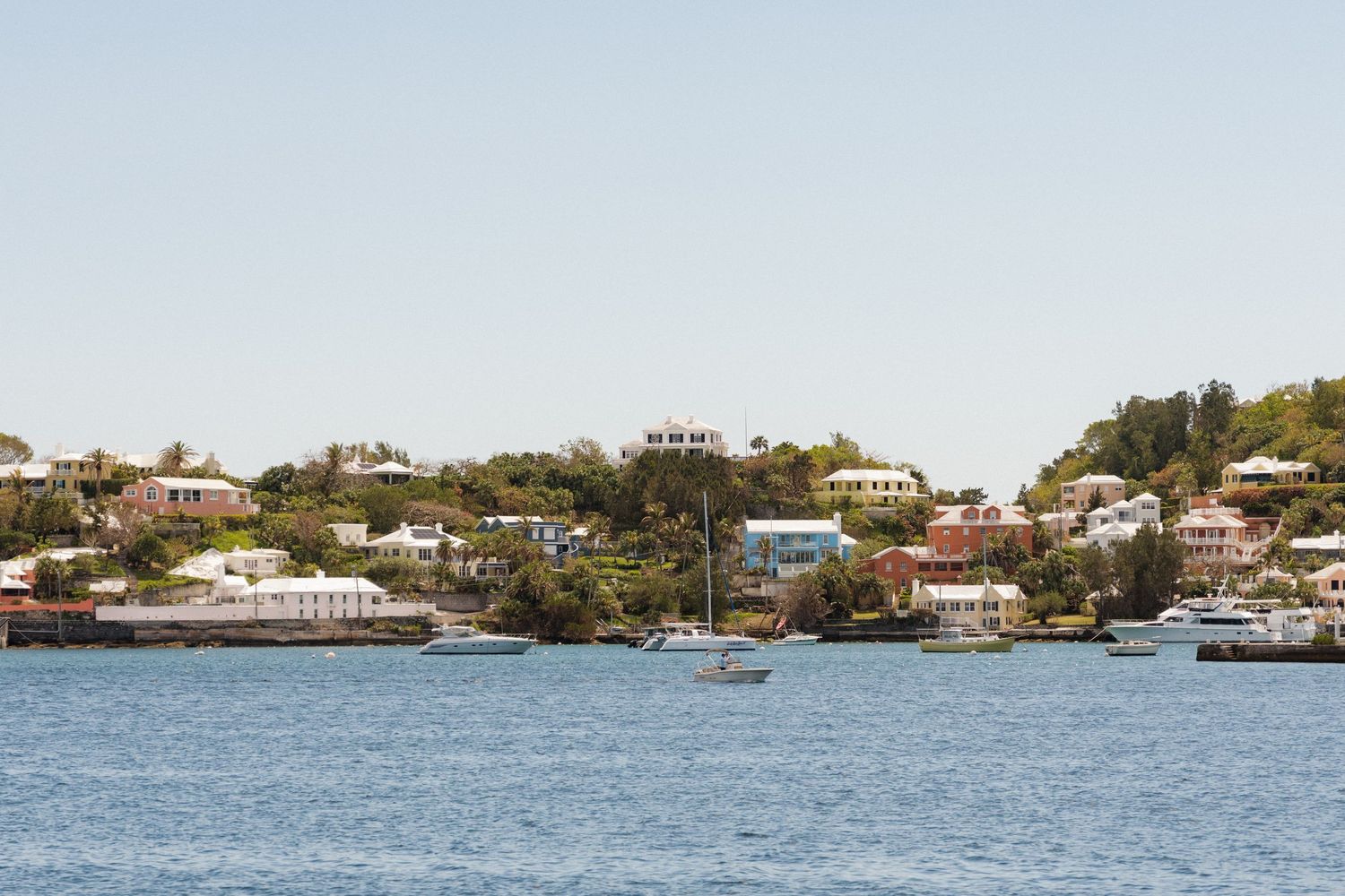 Scenic view of a coastal town with colorful buildings and boats on the water.