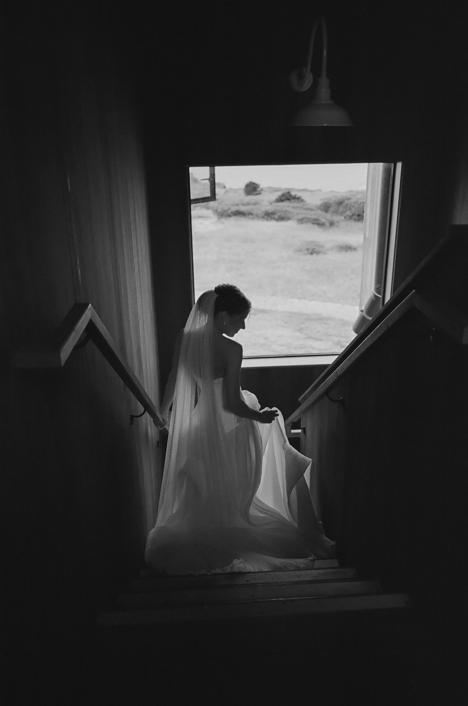 Silhouette of people by window getting ready for wedding ceremony.