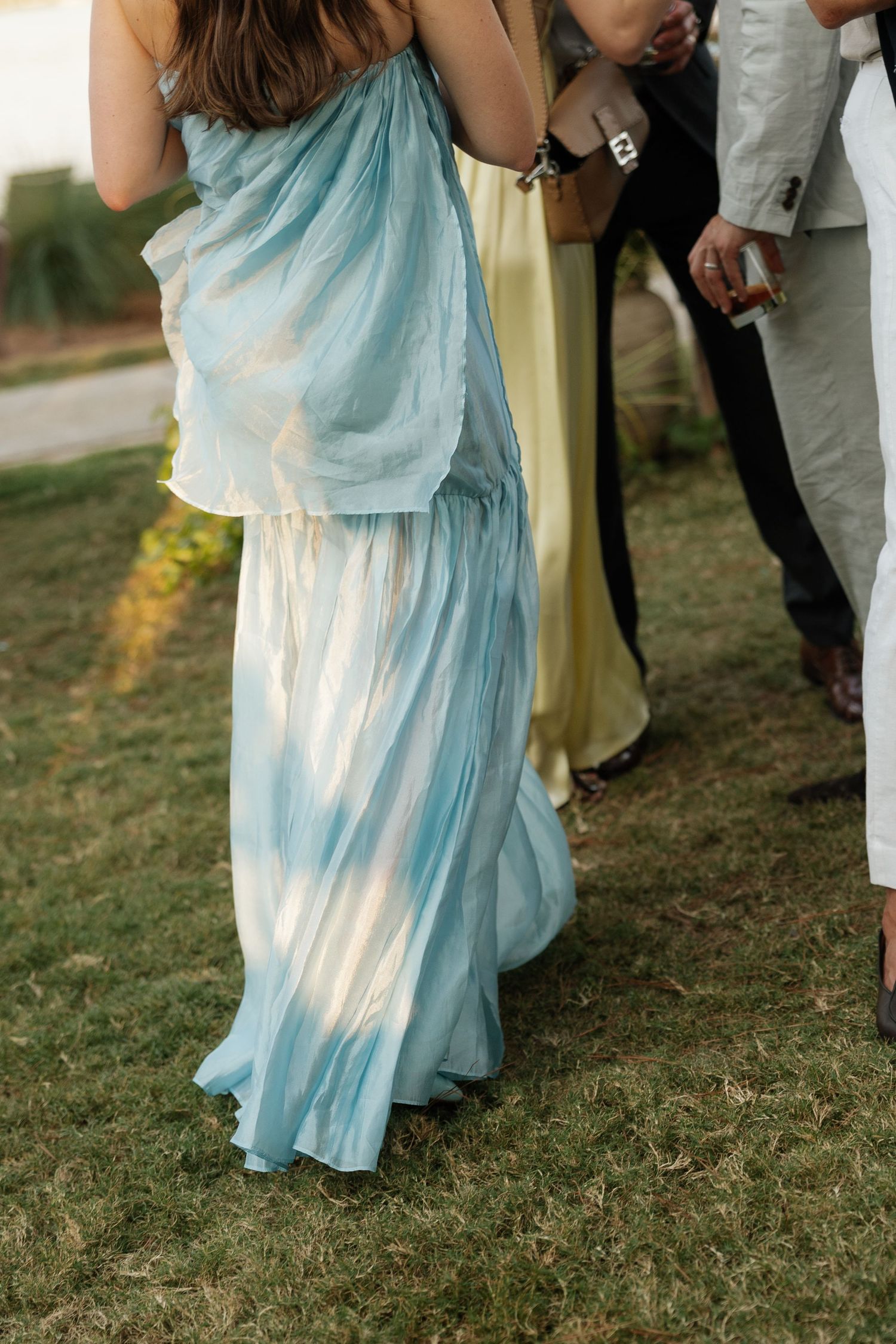 A flowing light blue tie-dye dress captured at an outdoor event.
