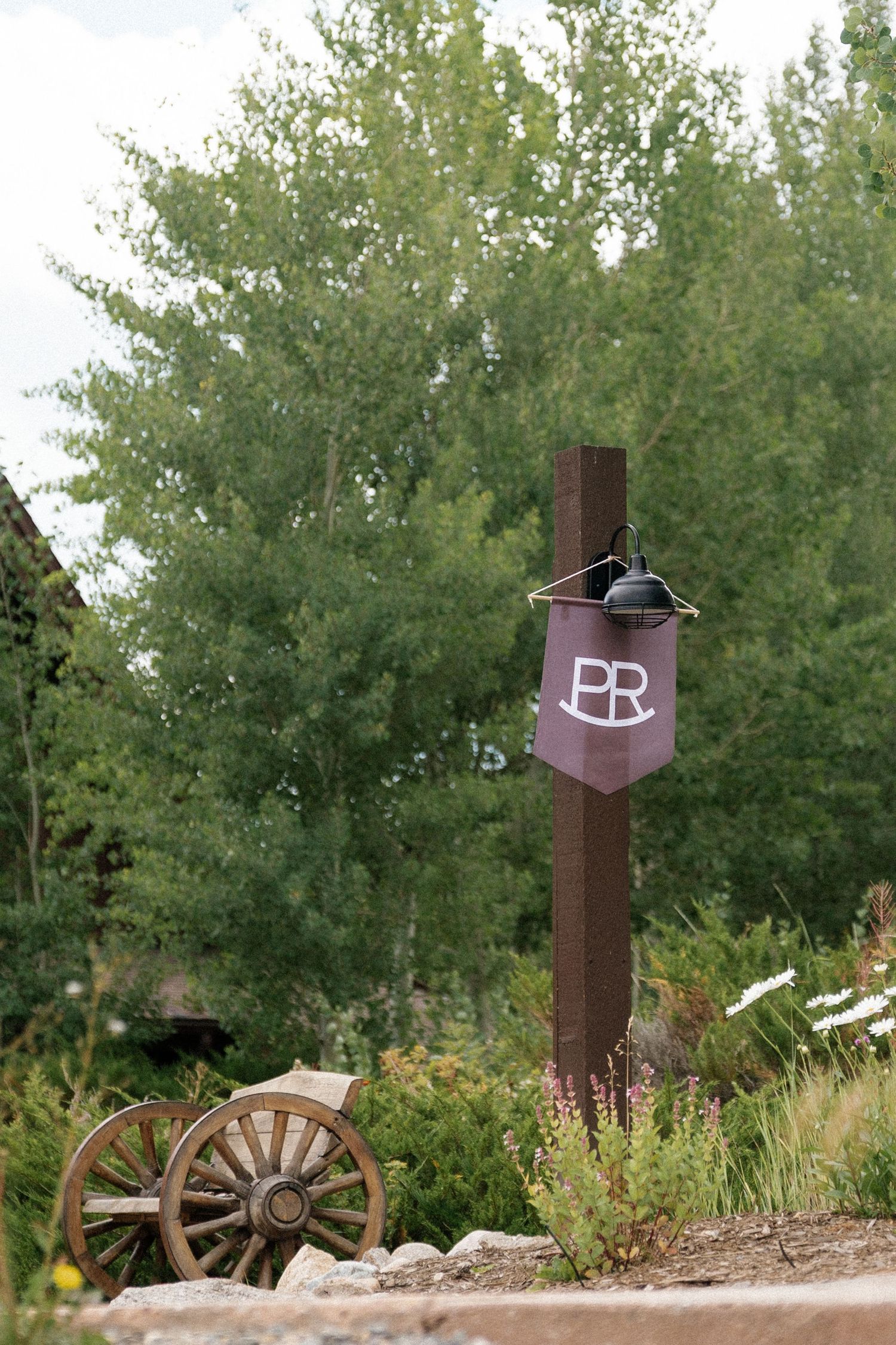 Rustic metal decorative posts with wagon wheel accents line an outdoor path.