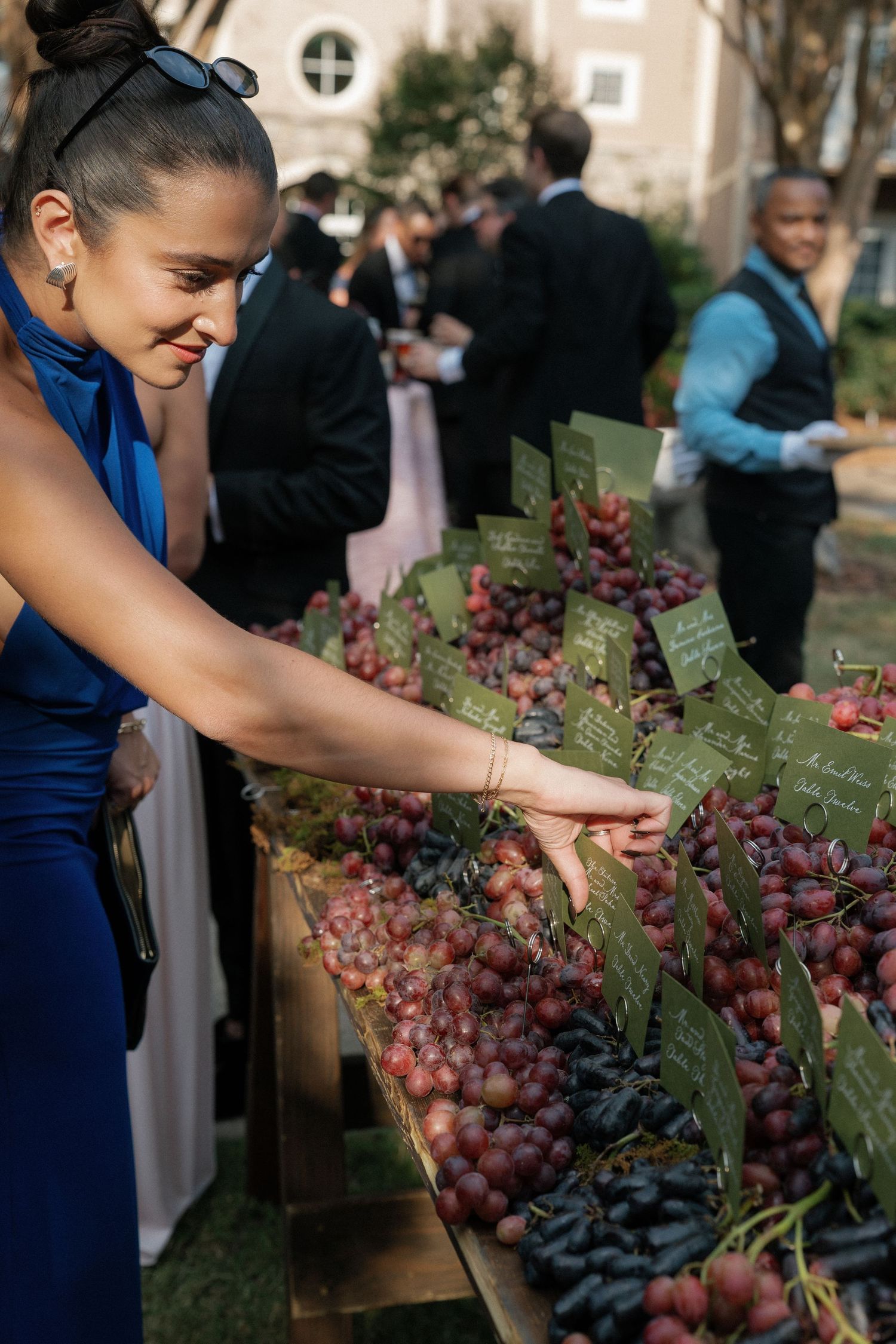 Close-up of fresh grapes and fruit display at an outdoor wedding reception.
