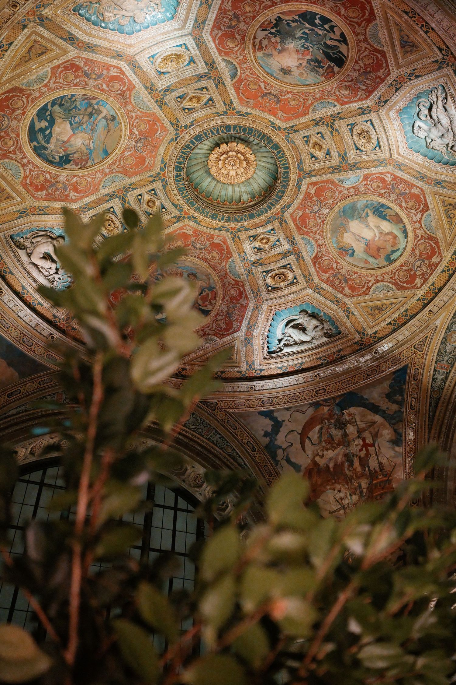The image shows an ornate, domed ceiling with intricate, colorful frescoes and decorative patterns.