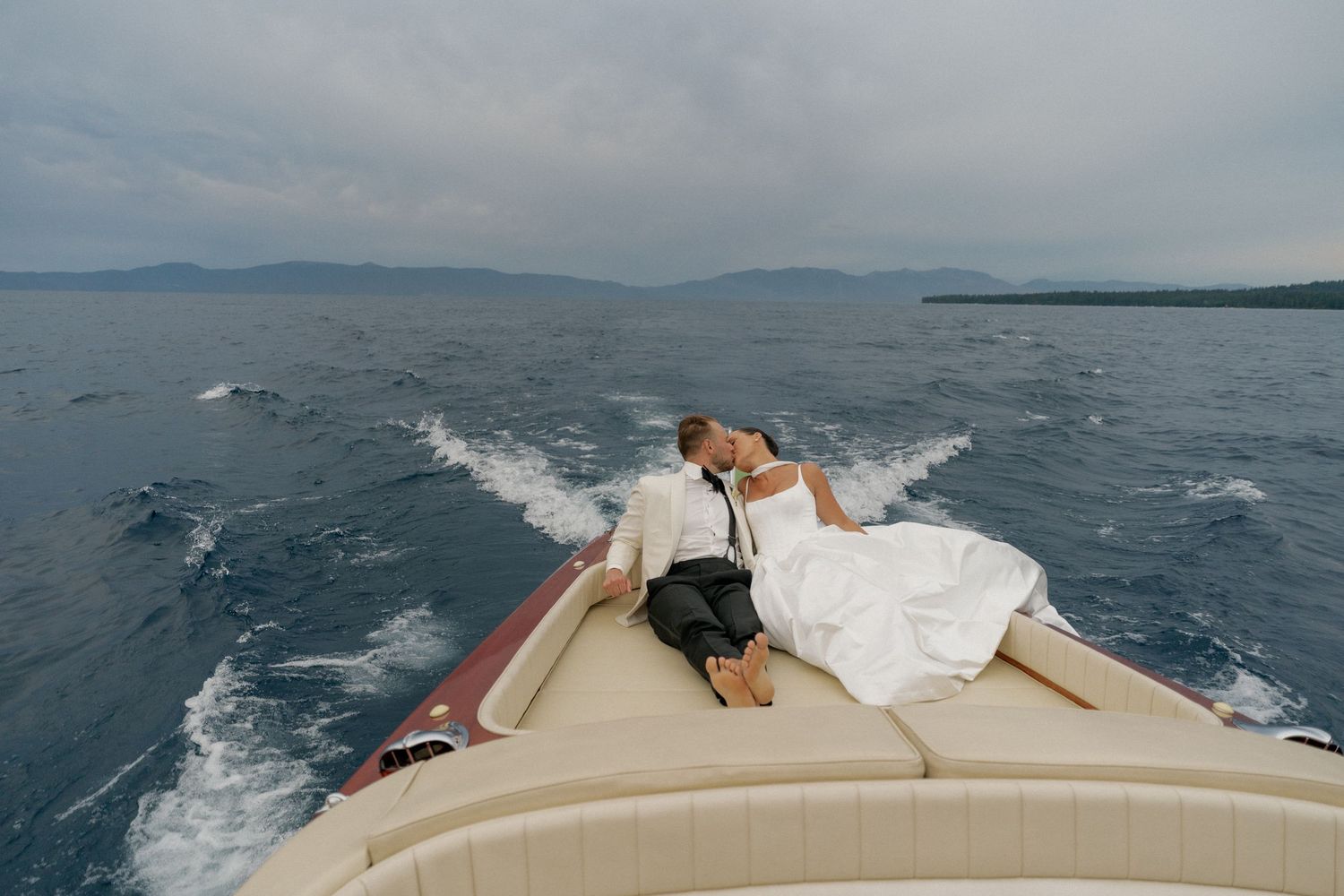 Scenic boat ride across blue waters with mountains in the background.