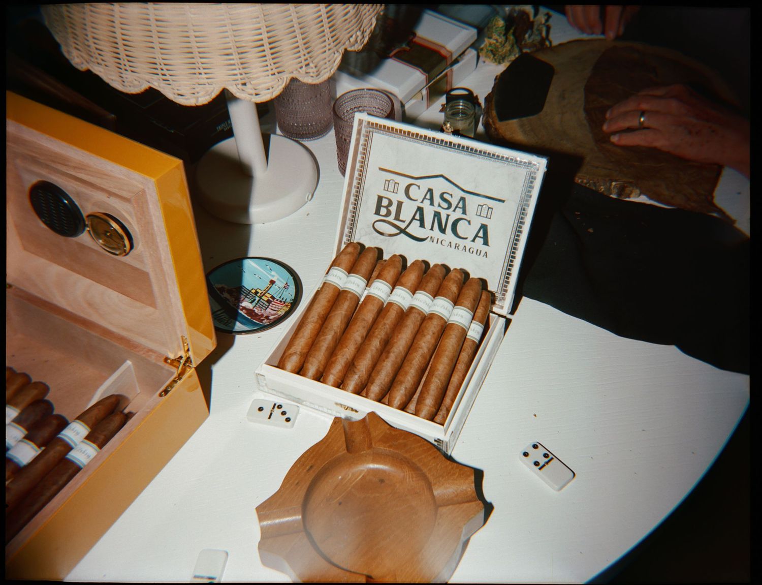 Casa Blanca cigar box displayed with ashtray and accessories on white surface.