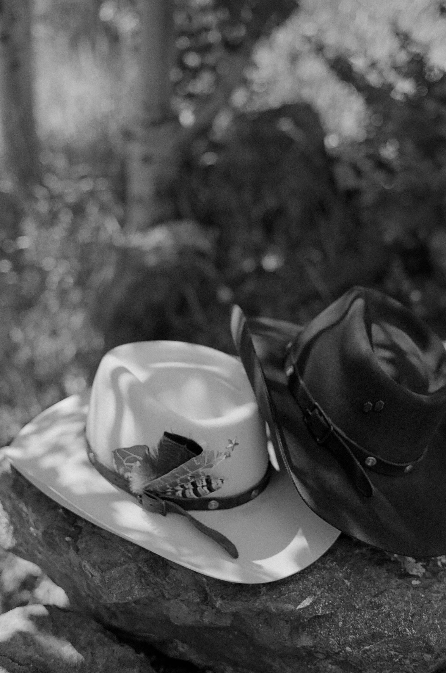 Black and white wedding rings resting on a rustic stone surface.