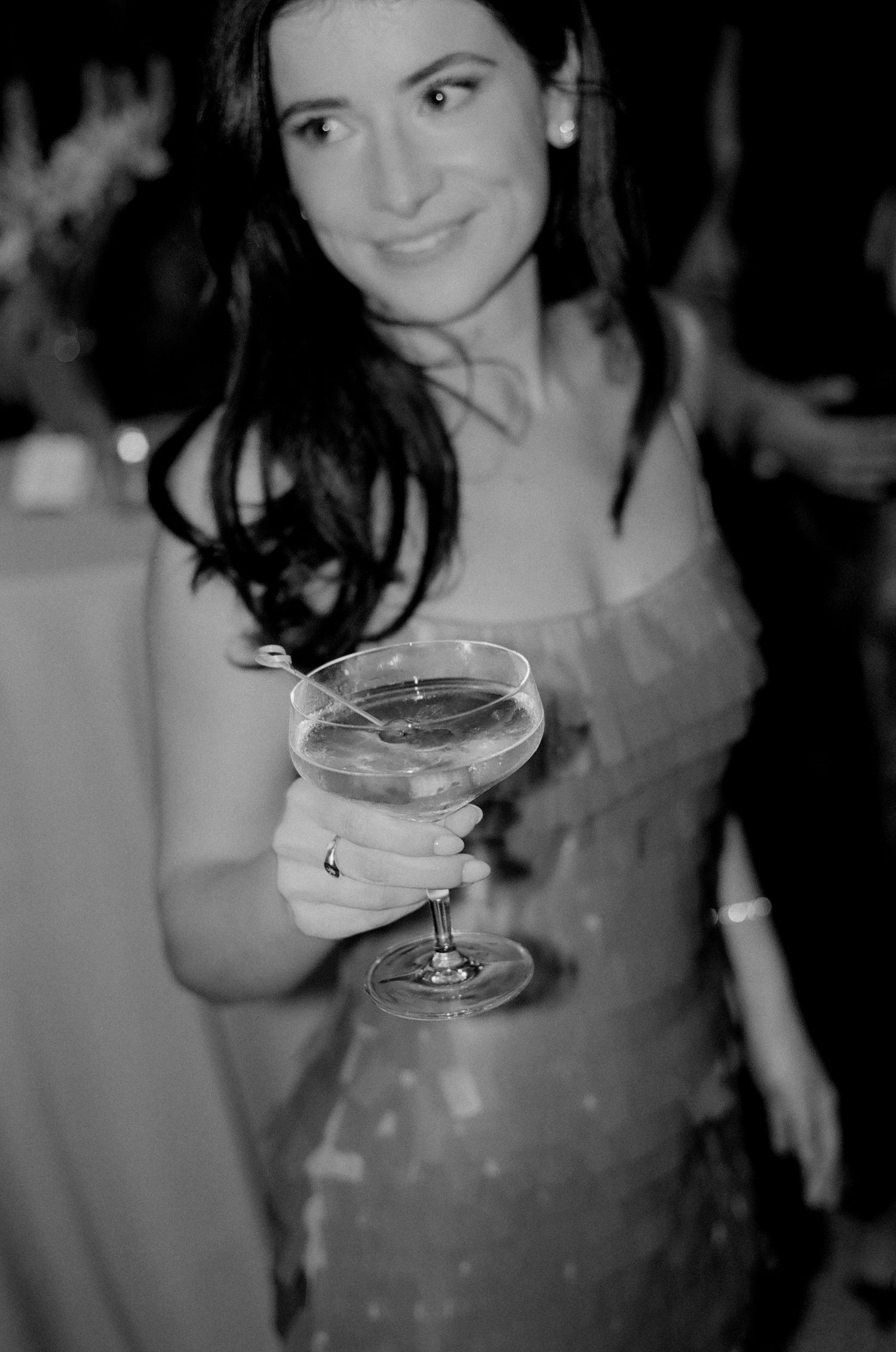 Black and white party scene with cocktail glasses and ambient lighting.