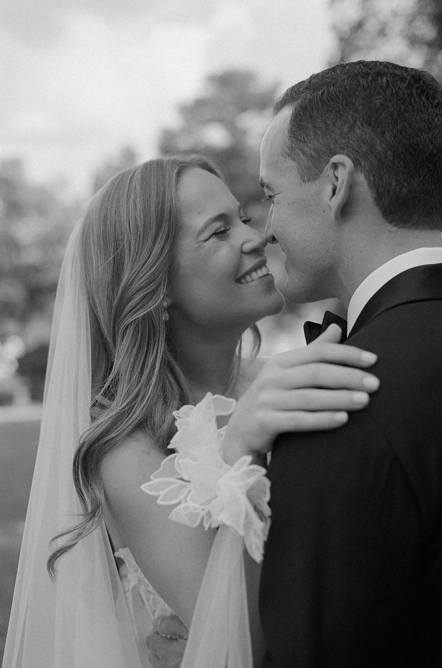 Black and white portrait of tender wedding moments between the couple.