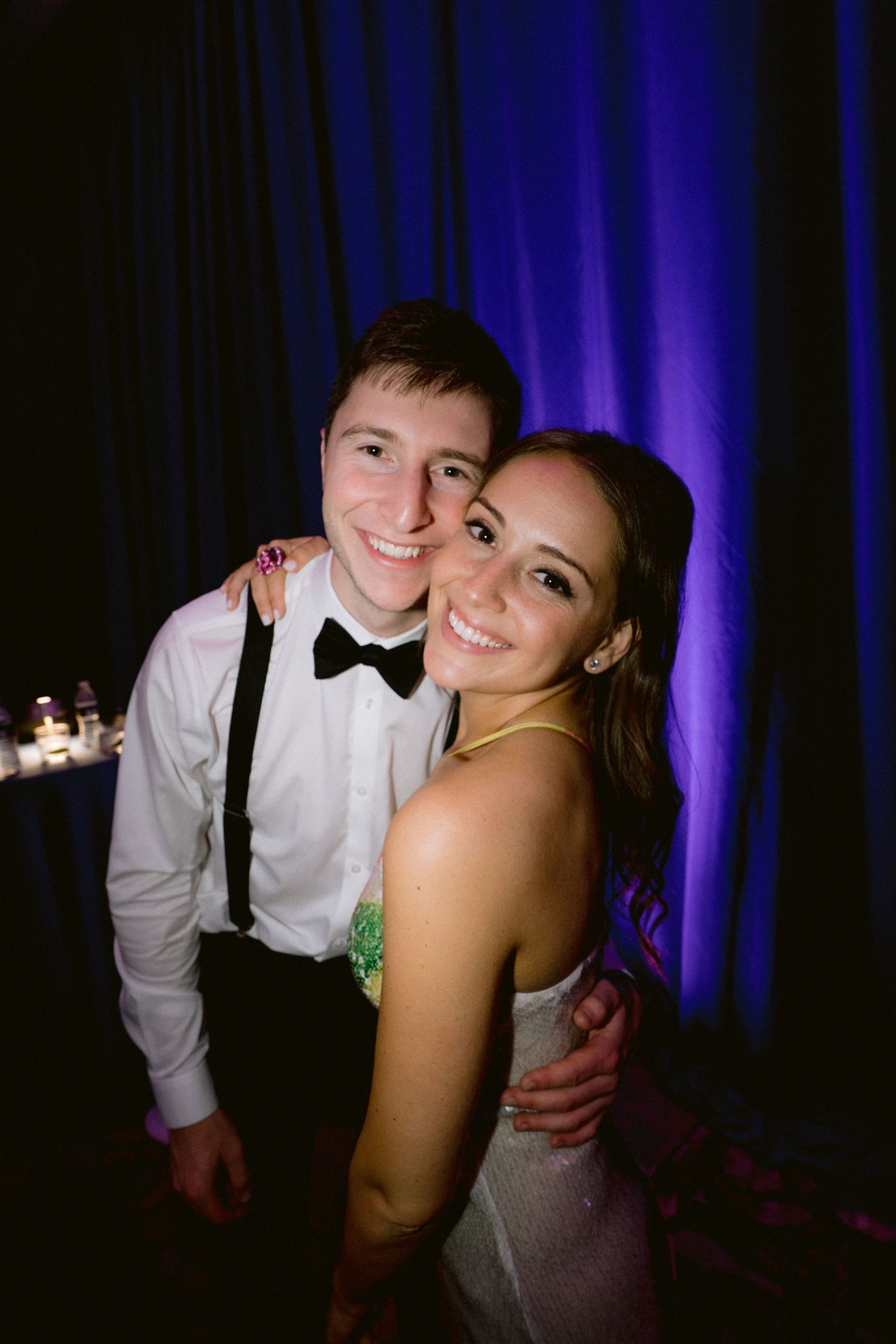Candid party photos with blue backdrop lighting at a celebration event.