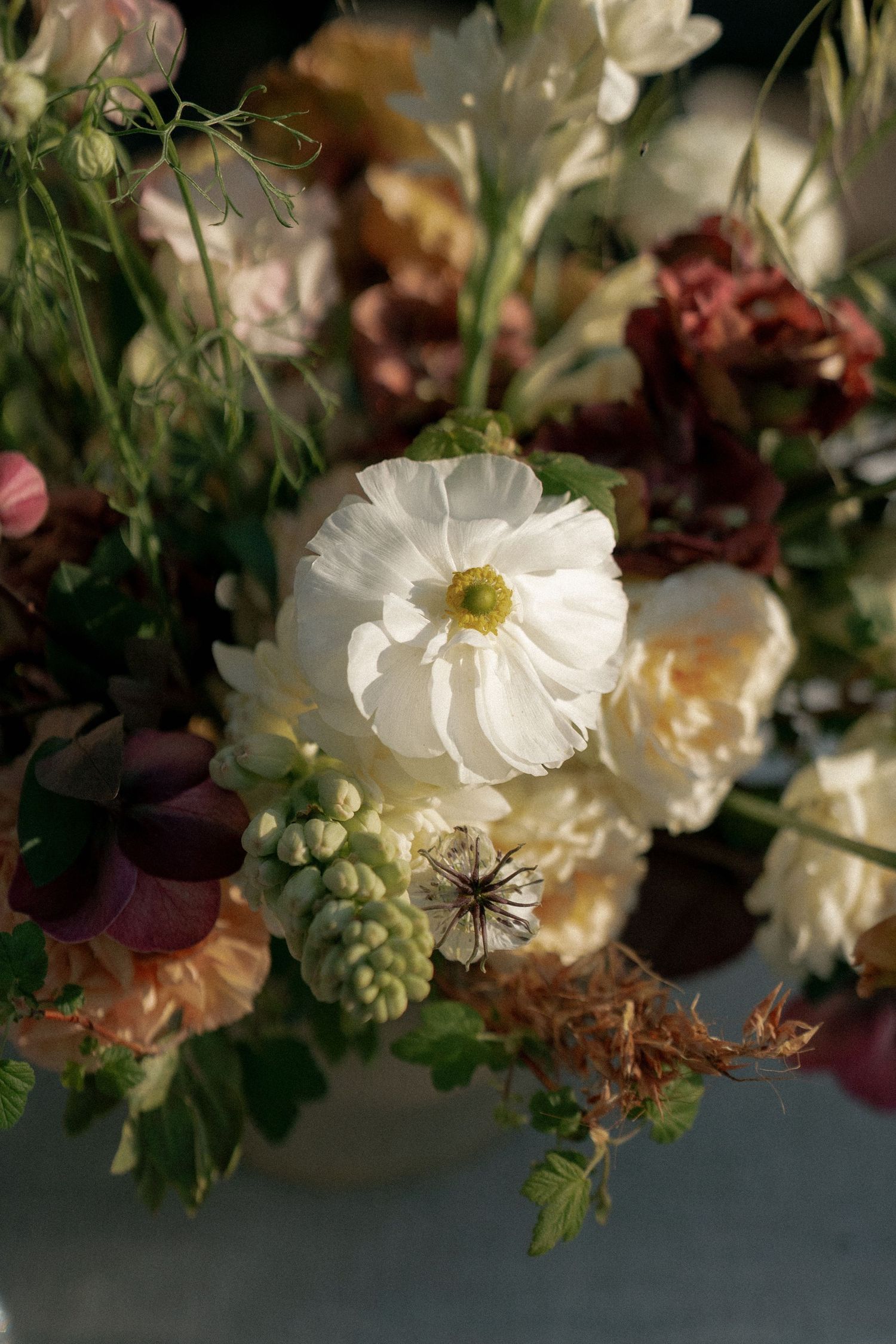 Delicate white flowers and greenery arranged in romantic wedding decor.