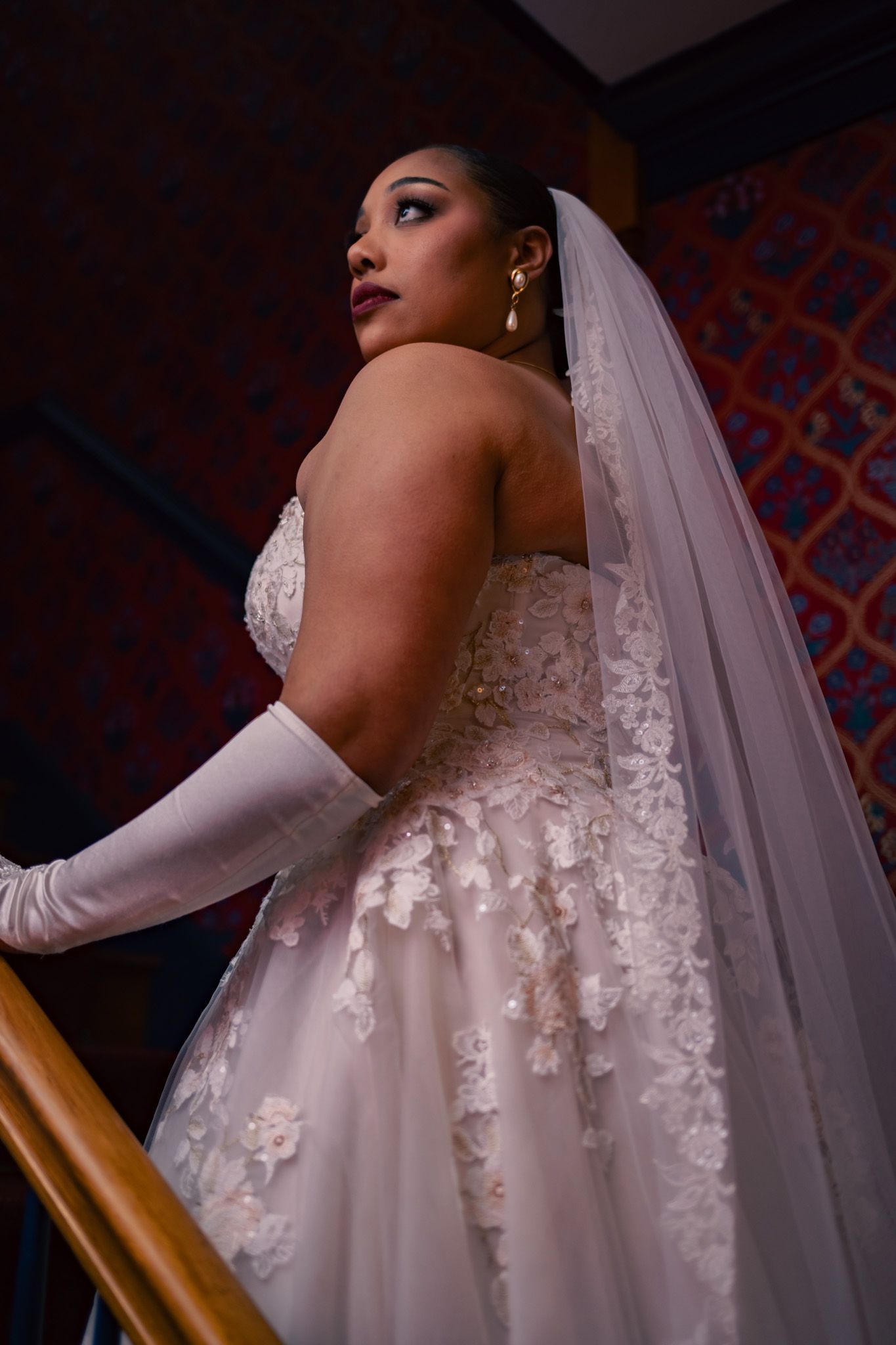 Close-up details of intricate lace wedding dress and veil.