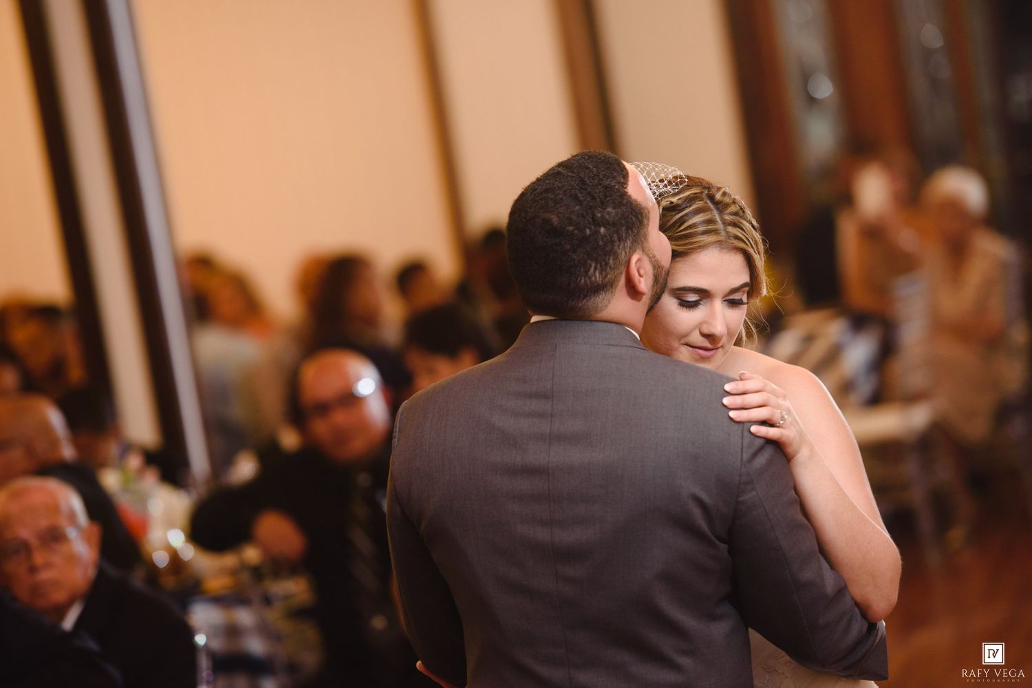Bride and groom share their first dance at elegant wedding reception.