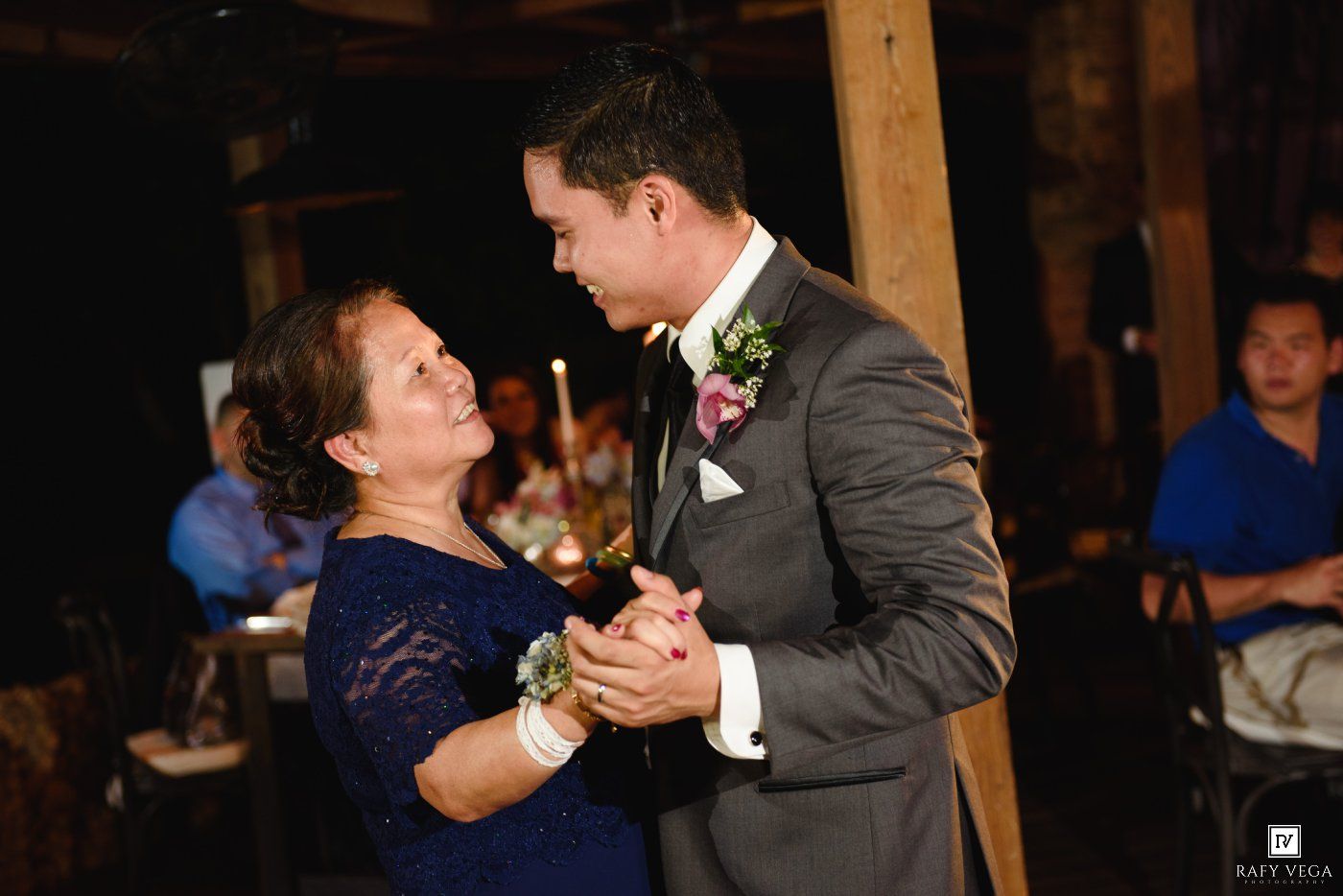 Groom shares special mother-son dance at elegant wedding reception.