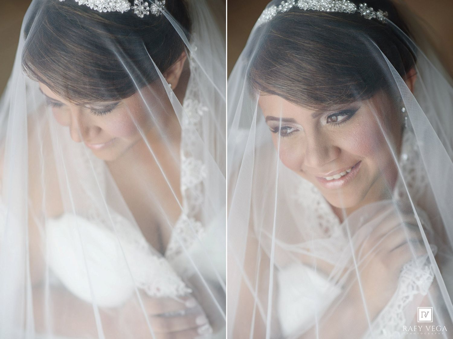 A beautiful bride in a lace wedding gown and tiara smiles softly beneath her flowing white veil.