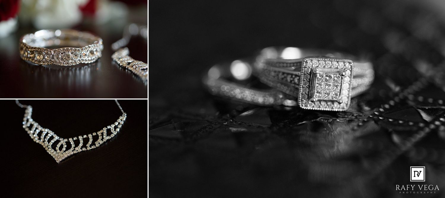 Elegant diamond engagement ring and wedding bands displayed on dark background with delicate necklace jewelry.