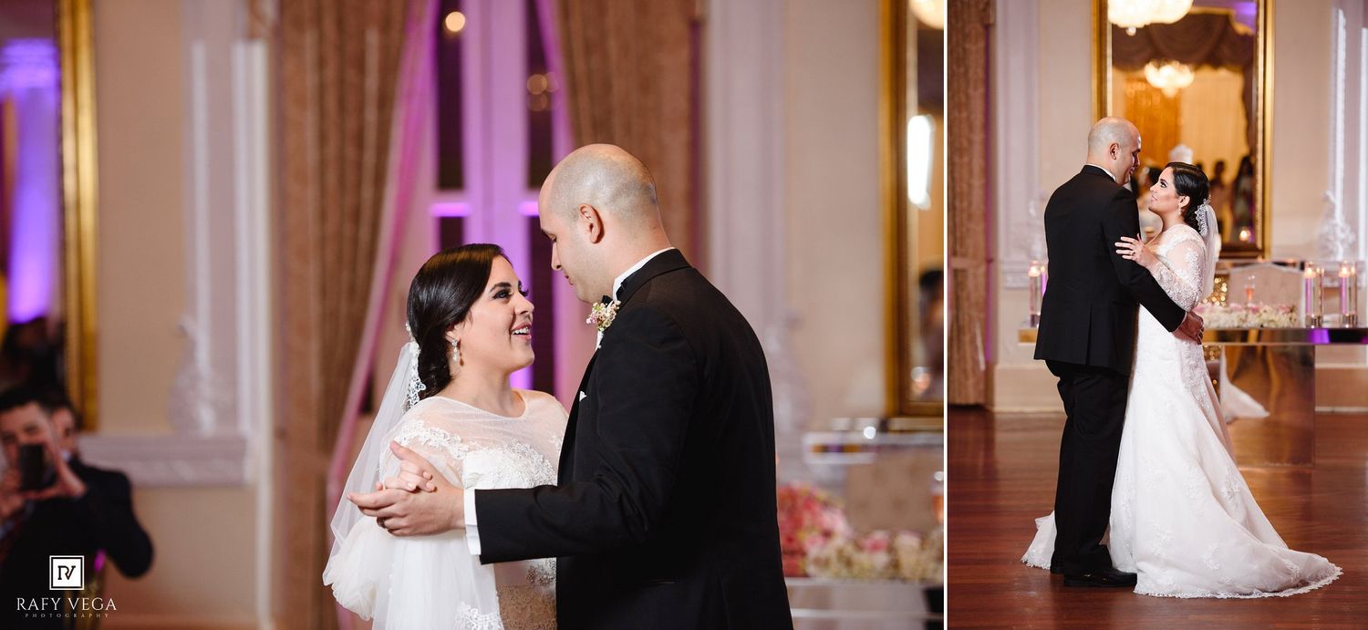 Bride and groom share their first dance at an elegant wedding reception with pink ambient lighting.