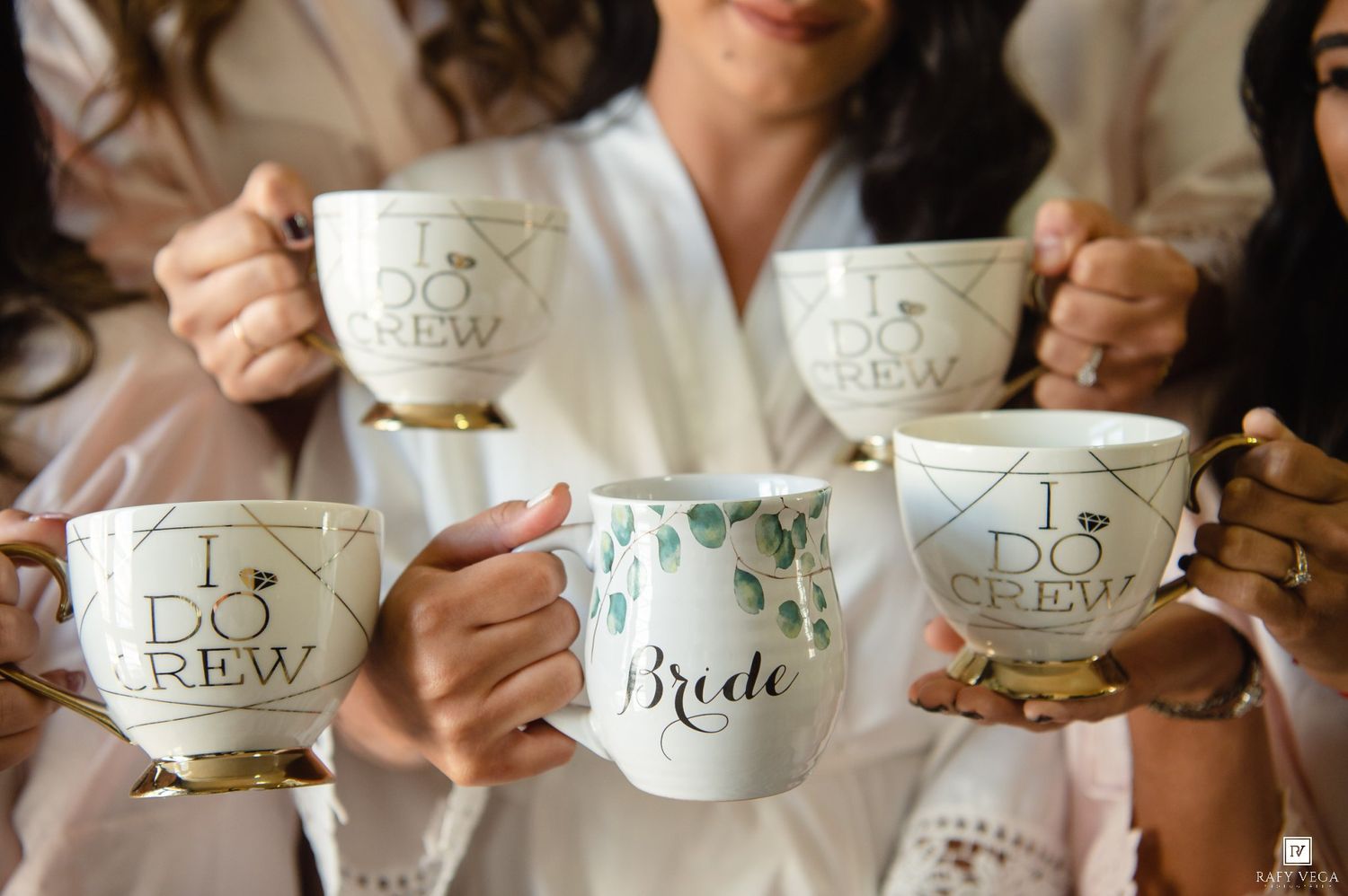 Bridesmaids holding white and gold 
