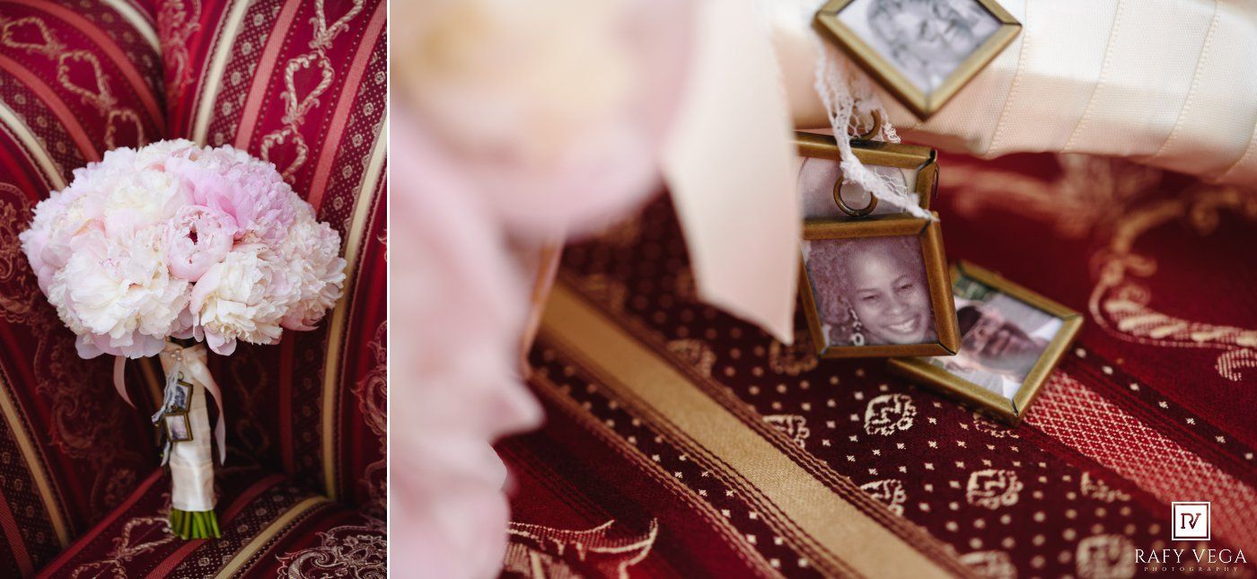 Elegant wedding flat lay featuring pink peony bridal bouquet and framed photos on red patterned fabric.