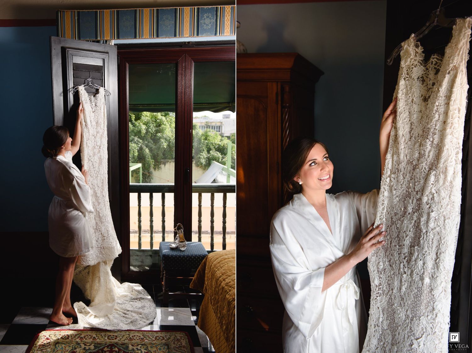 Bride in white robe admiring her wedding gown displayed near a window in an elegant room.