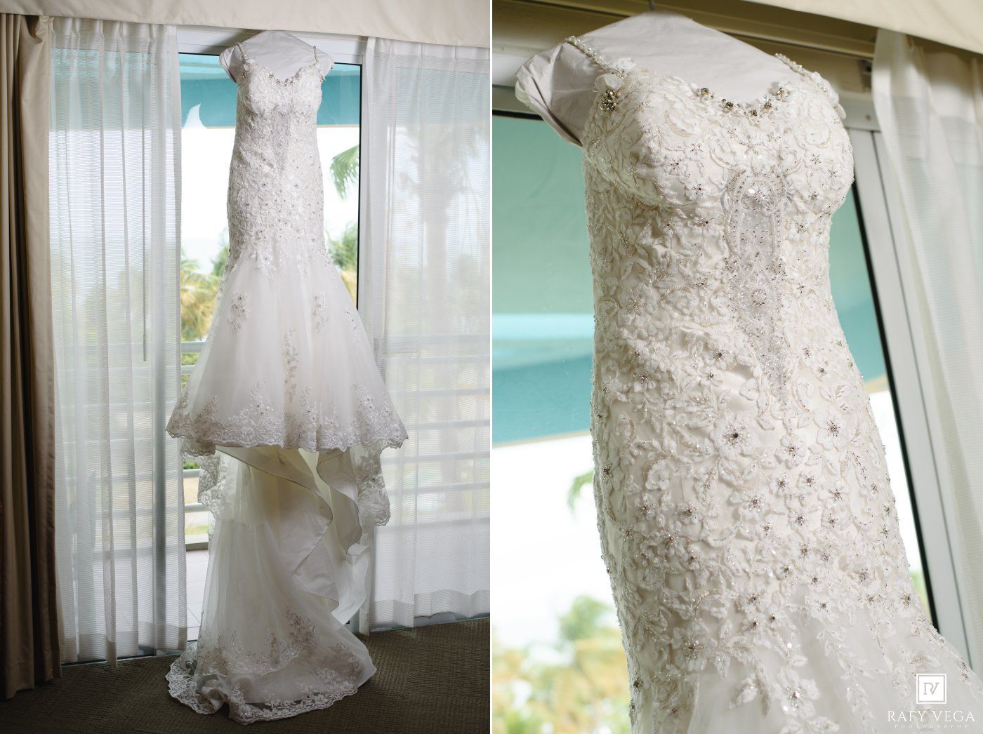 Elegant white mermaid wedding dress with lace detailing hanging by a window with sheer curtains.