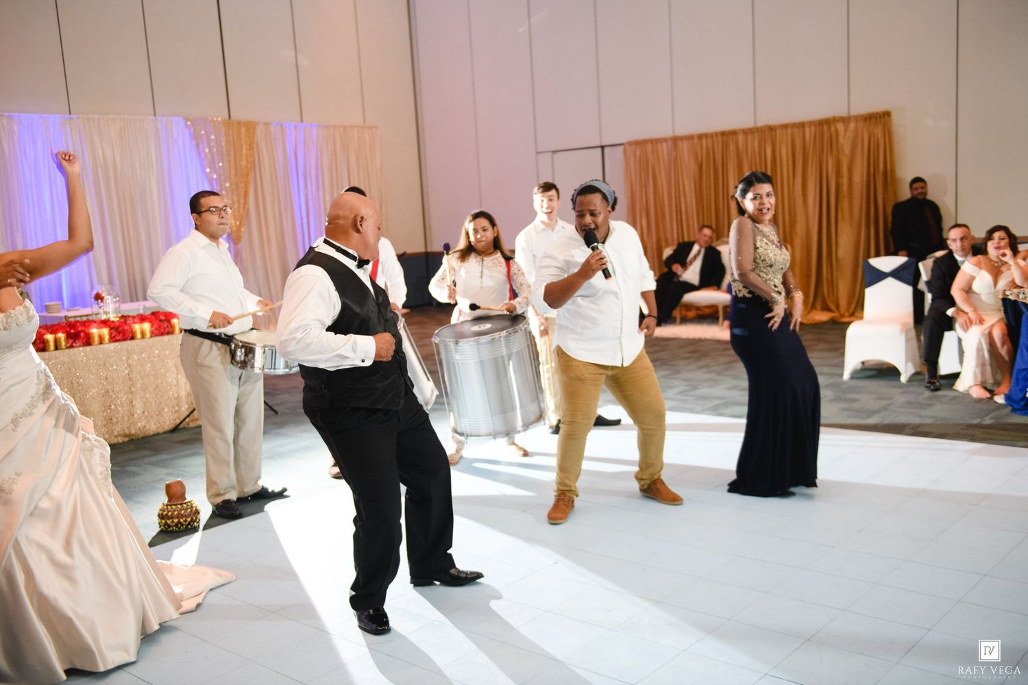 Live steel drum performance at an elegant wedding reception with guests dancing in a decorated ballroom.
