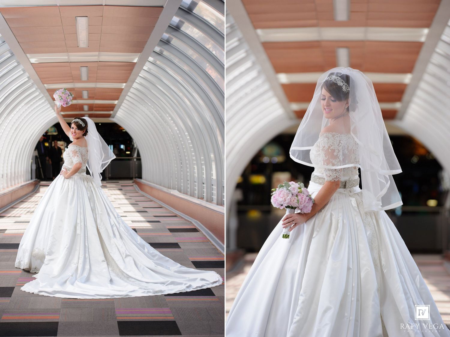 Bride in elegant white ball gown with veil holding pink bouquet posing in modern architectural corridor.