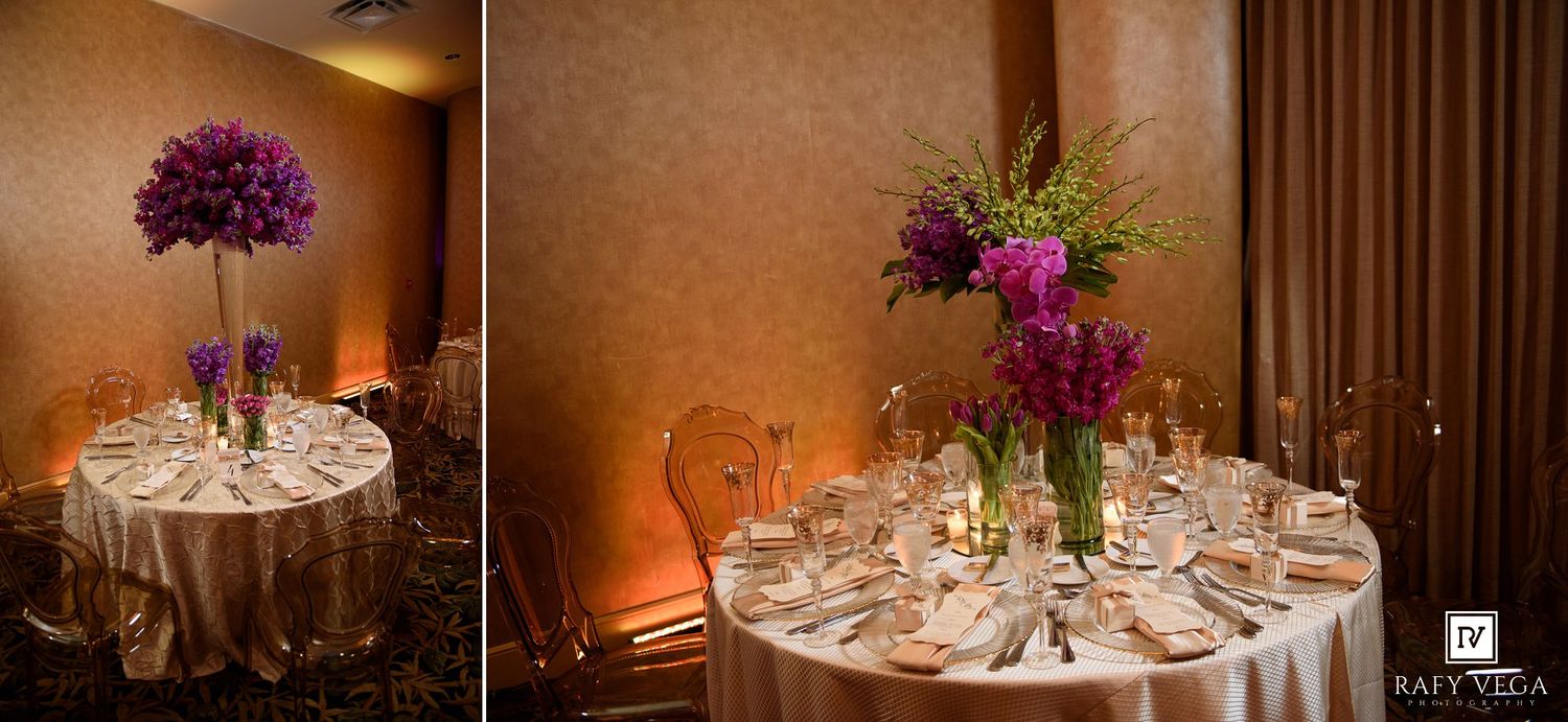 Elegant wedding reception tables adorned with tall purple floral centerpieces and gold linens in a warmly lit ballroom.