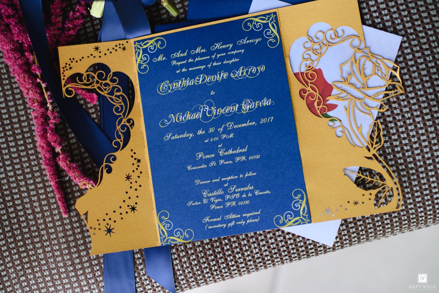 Beauty and the Beast themed wedding invitation in royal blue and gold with ornate laser-cut design and elegant calligraphy.