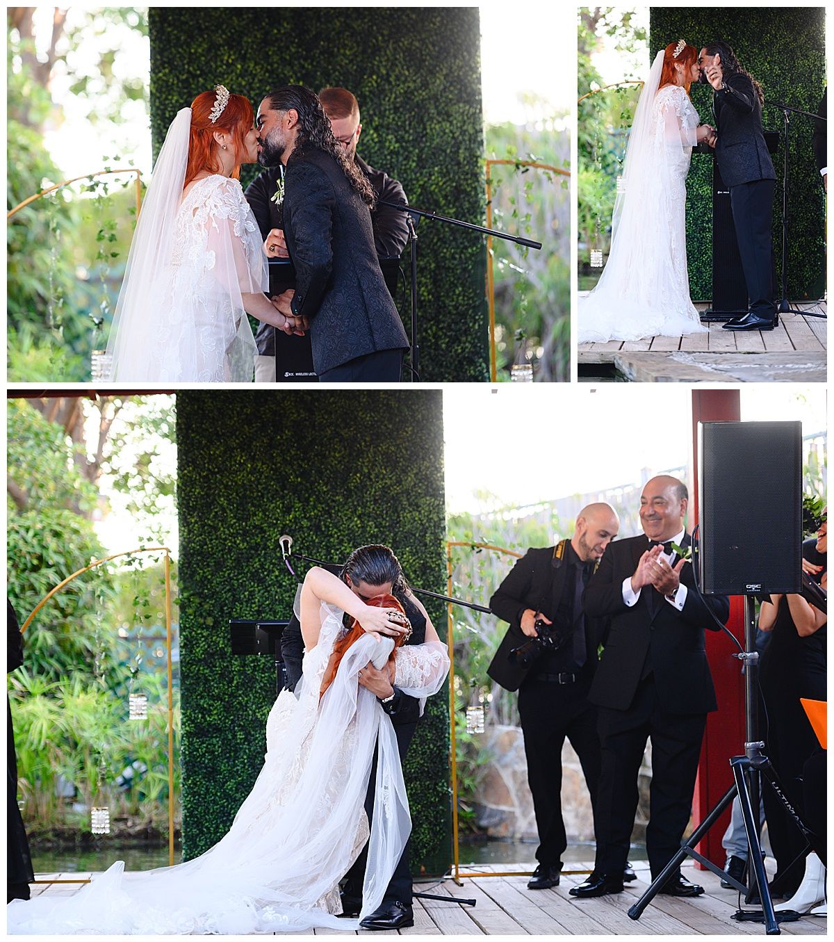 Bride and groom share first kiss at outdoor wedding ceremony with green hedge backdrop, surrounded by guests.