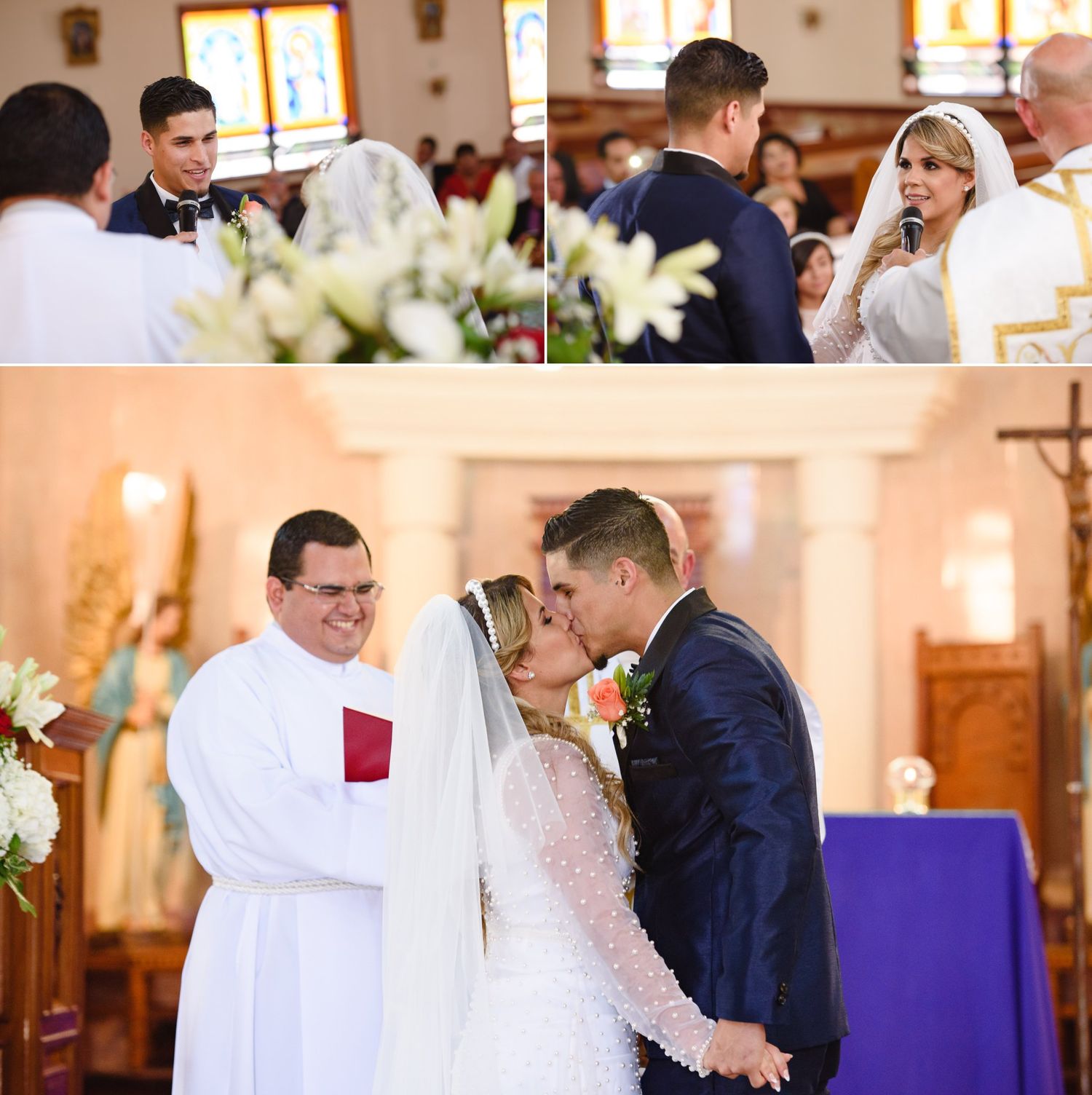 Bride and groom share first kiss at Catholic church wedding ceremony with smiling priest officiating.