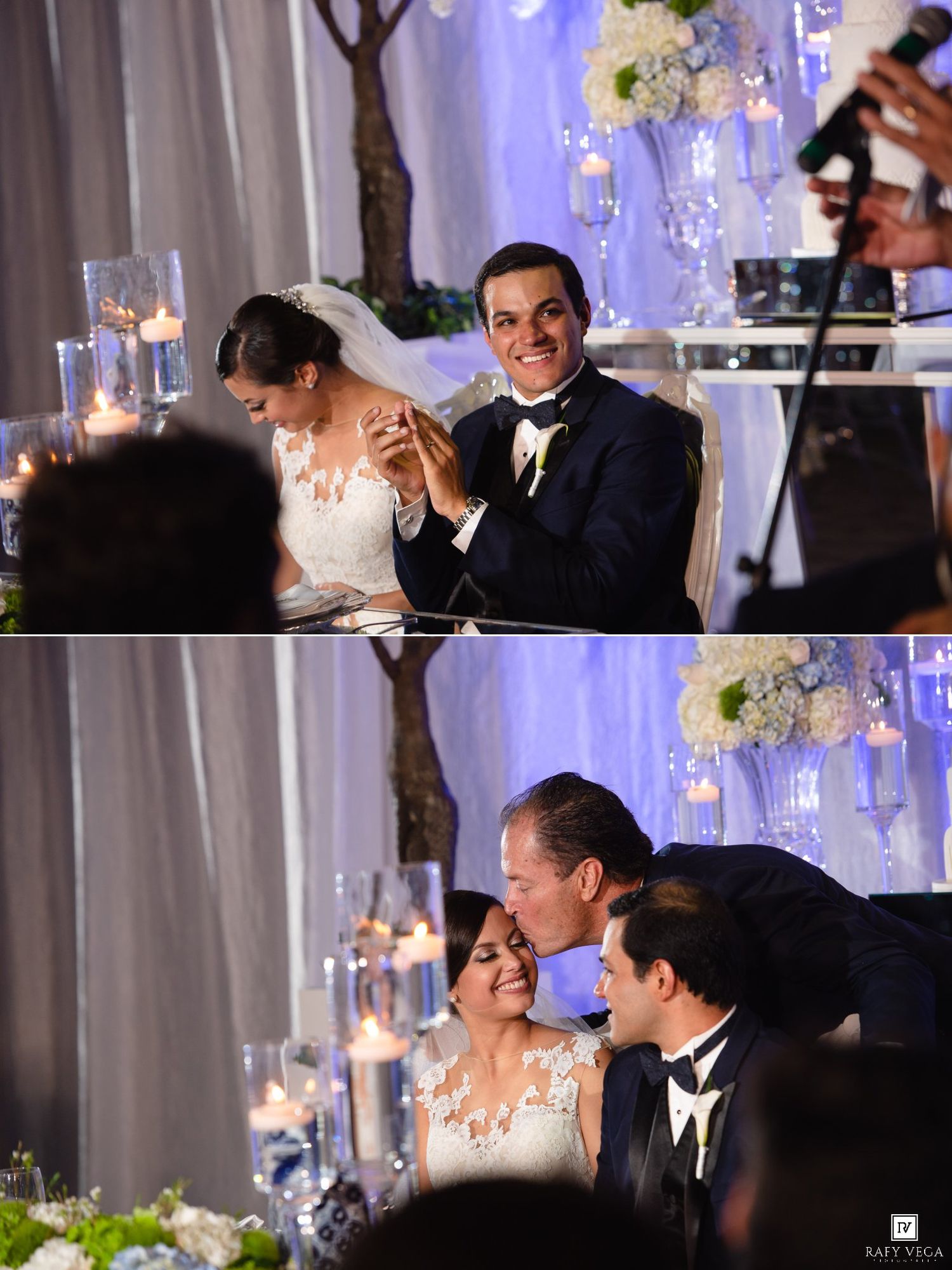 Bride and groom share a joyful moment at their elegant wedding reception table adorned with candles and floral arrangements.