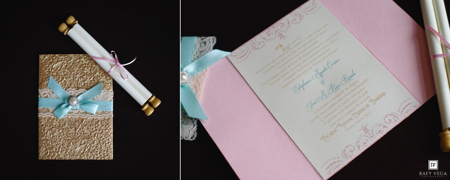 Elegant wedding invitation set featuring a gold scroll, teal ribbon, and pink folded card with decorative script detailing.