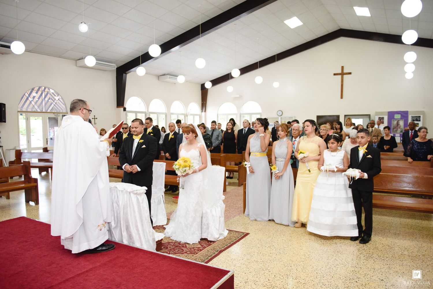 Traditional church wedding ceremony with bride, groom, and wedding party at the altar.