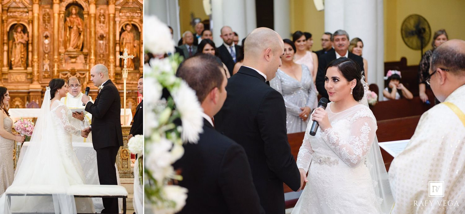 Bride and groom exchange vows at elegant church wedding ceremony with white floral decorations and guests seated in pews.