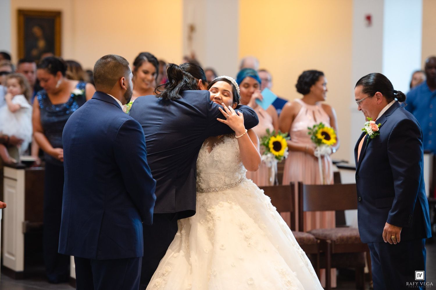 Bride and groom share a warm embrace at the altar during their church wedding ceremony.