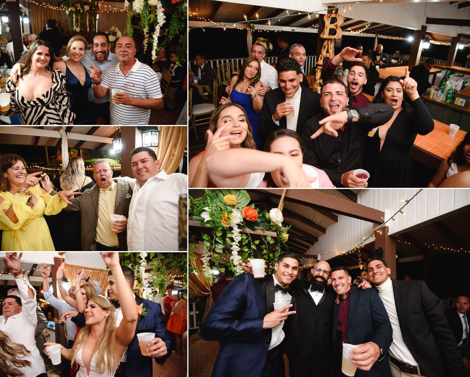 Joyful wedding reception guests dancing and posing for photos in a warmly lit rustic venue.