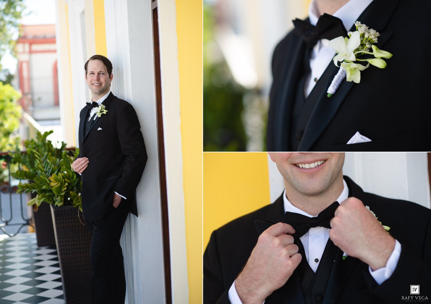 Groom in black tuxedo with white boutonniere posing outdoors, adjusting bow tie in close-up wedding portrait.