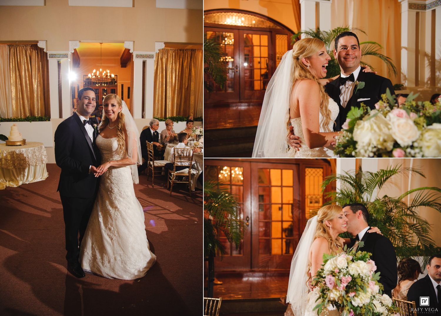 Elegant wedding couple posing in a grand ballroom venue with floral bouquet and formal attire.