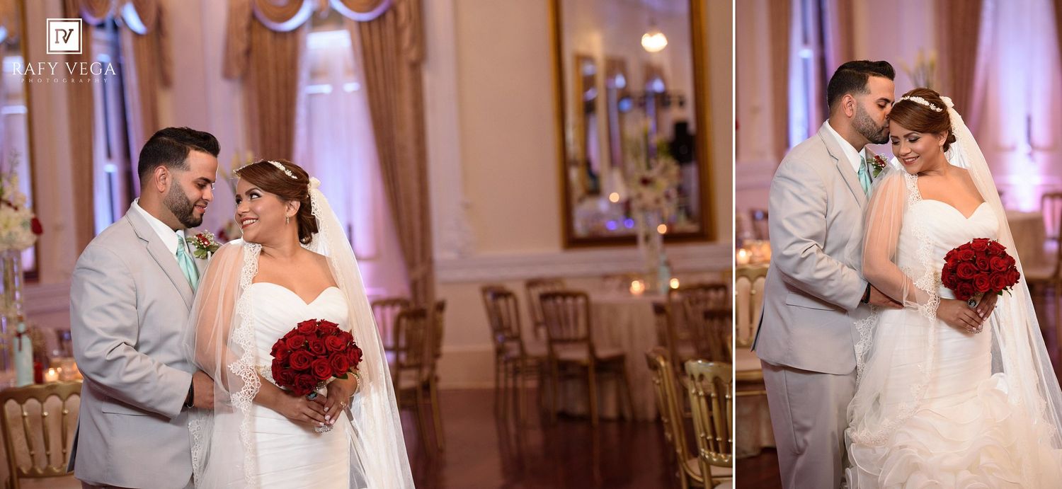 A bride and groom share tender moments in an elegant gold ballroom, bride holding red roses bouquet in wedding attire.