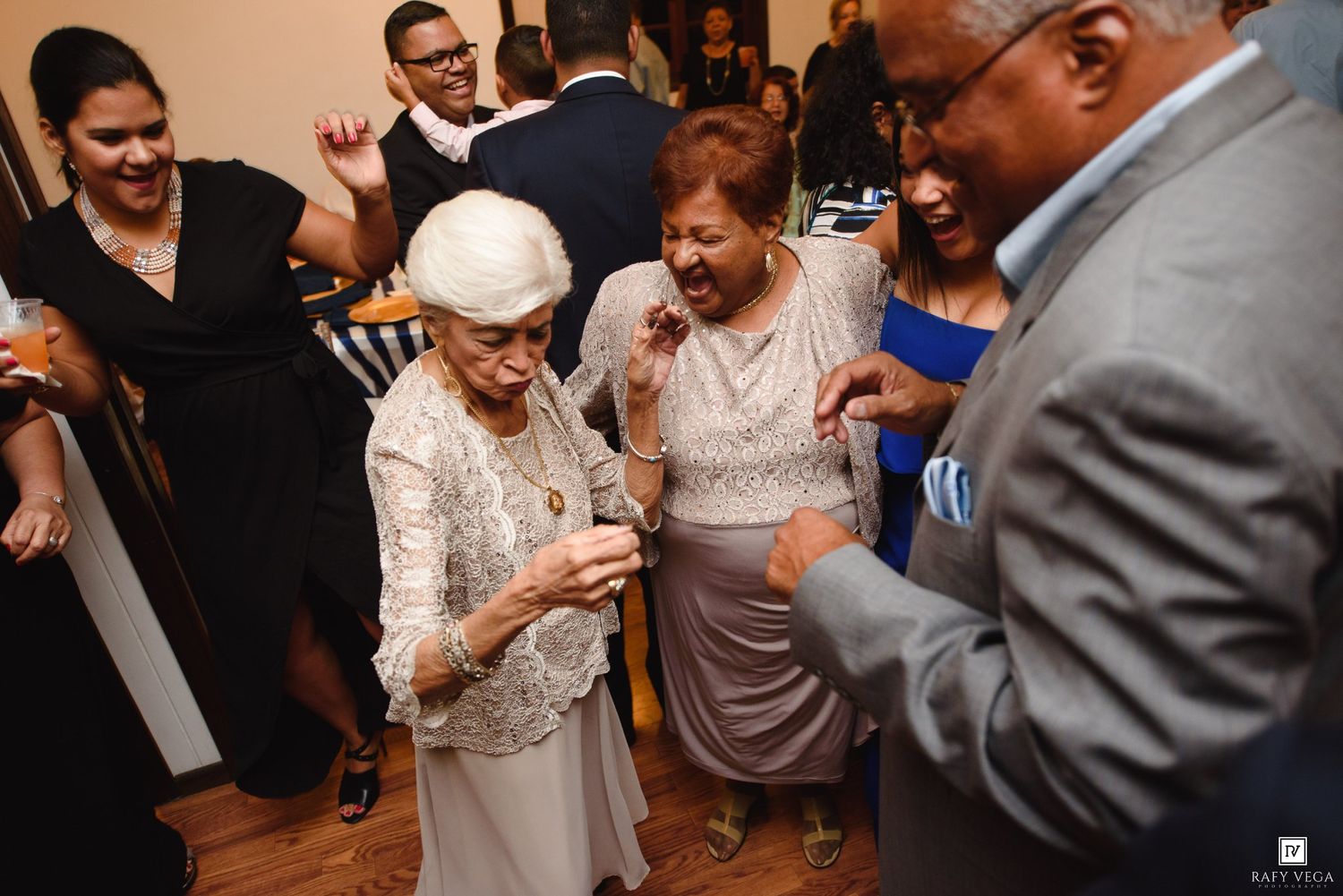 Elderly guests joyfully dancing together at a lively wedding reception.
