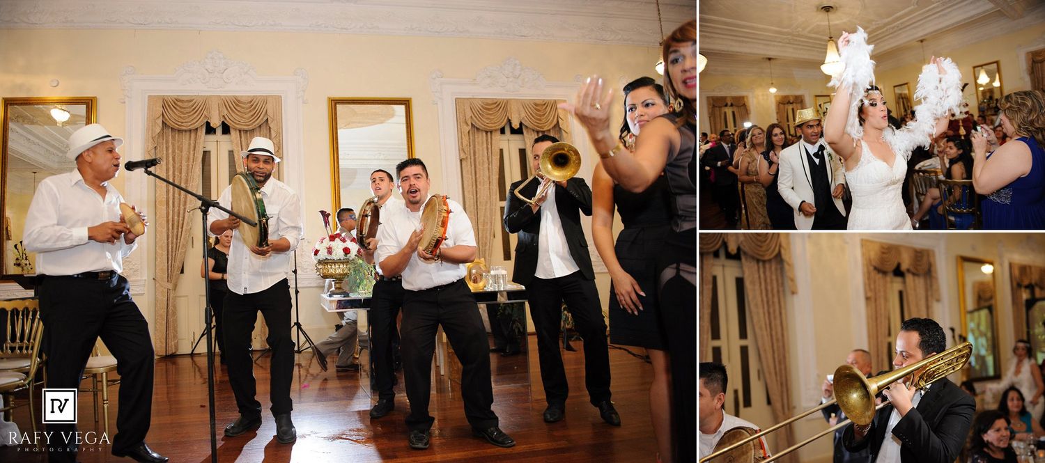 A lively wedding reception band performs with brass instruments as guests celebrate in an elegant white ballroom.